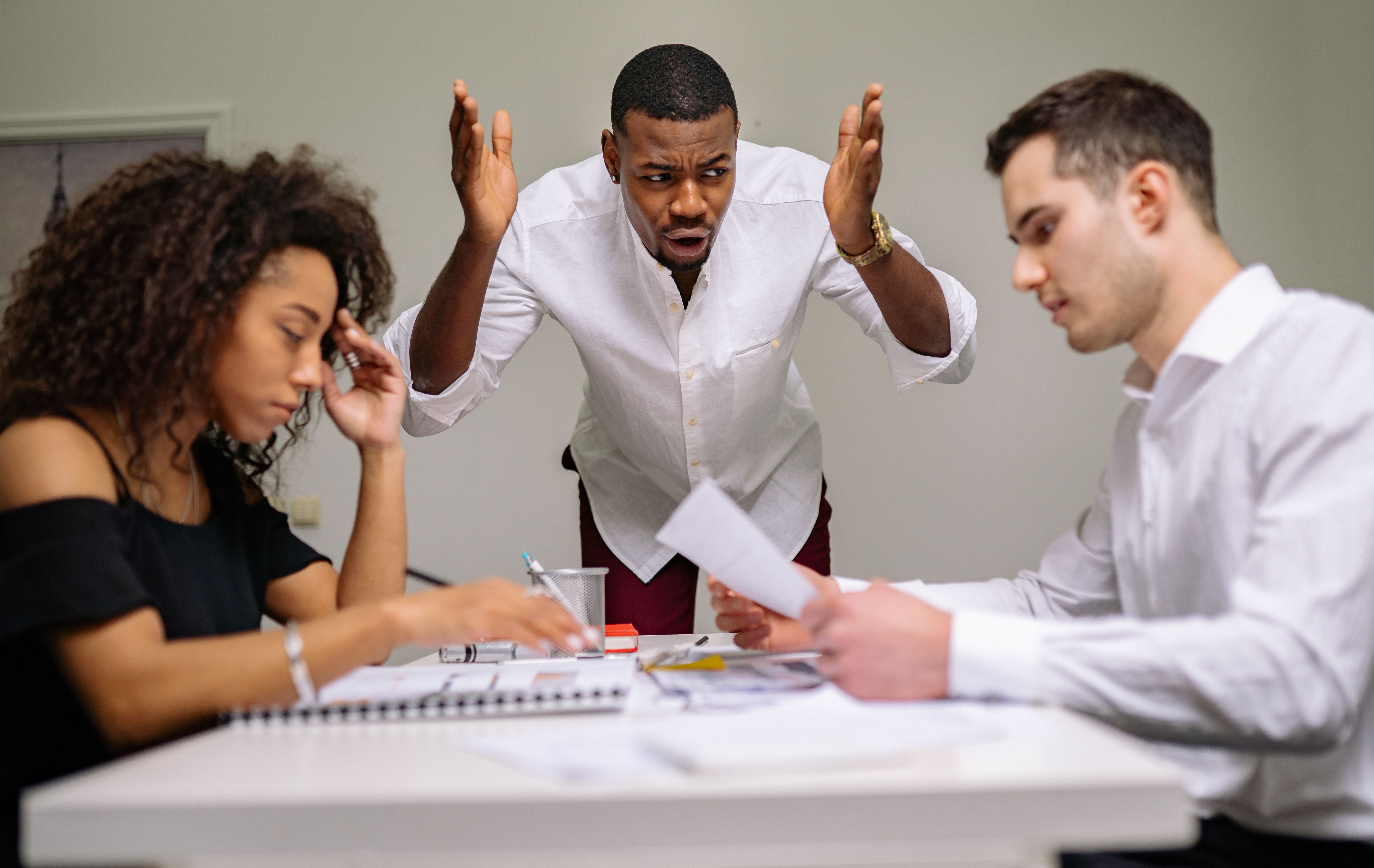 Colleagues in a heated argument at the office during a tense boardroom discussion