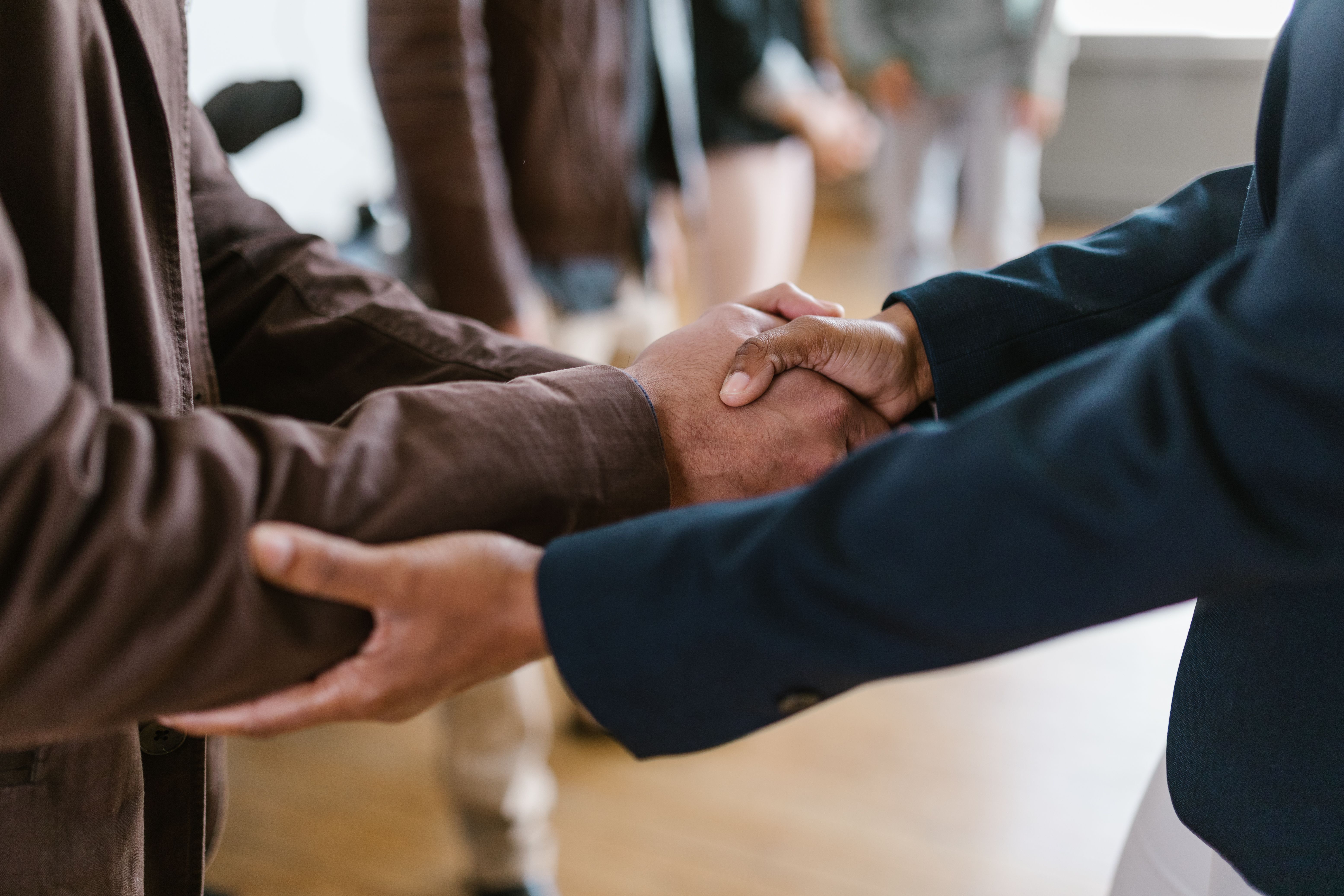 Close-up of an investor and founder shaking hands to seal a deal