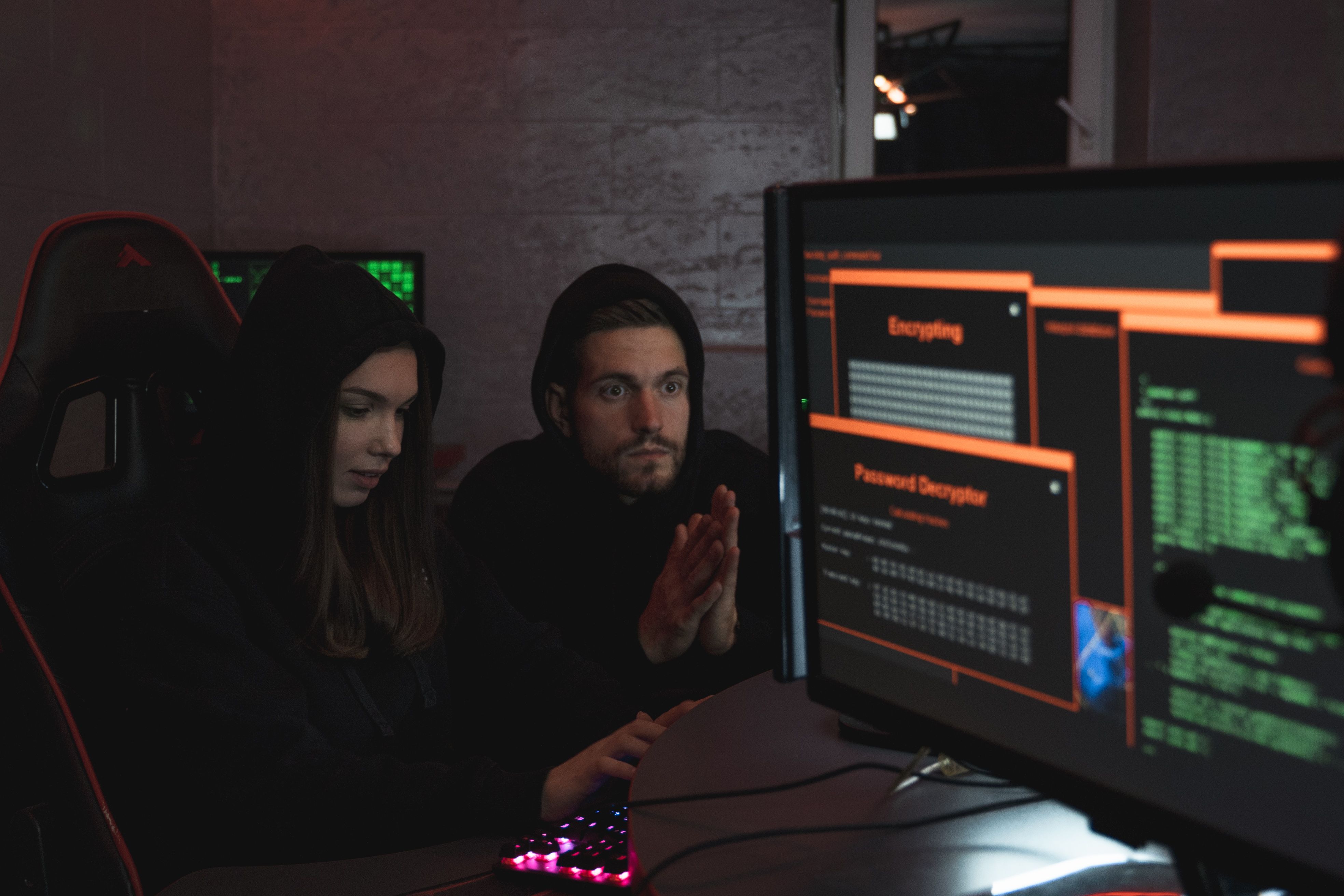 Cybersecurity experts analyzing encrypted threat data across multiple computer screens