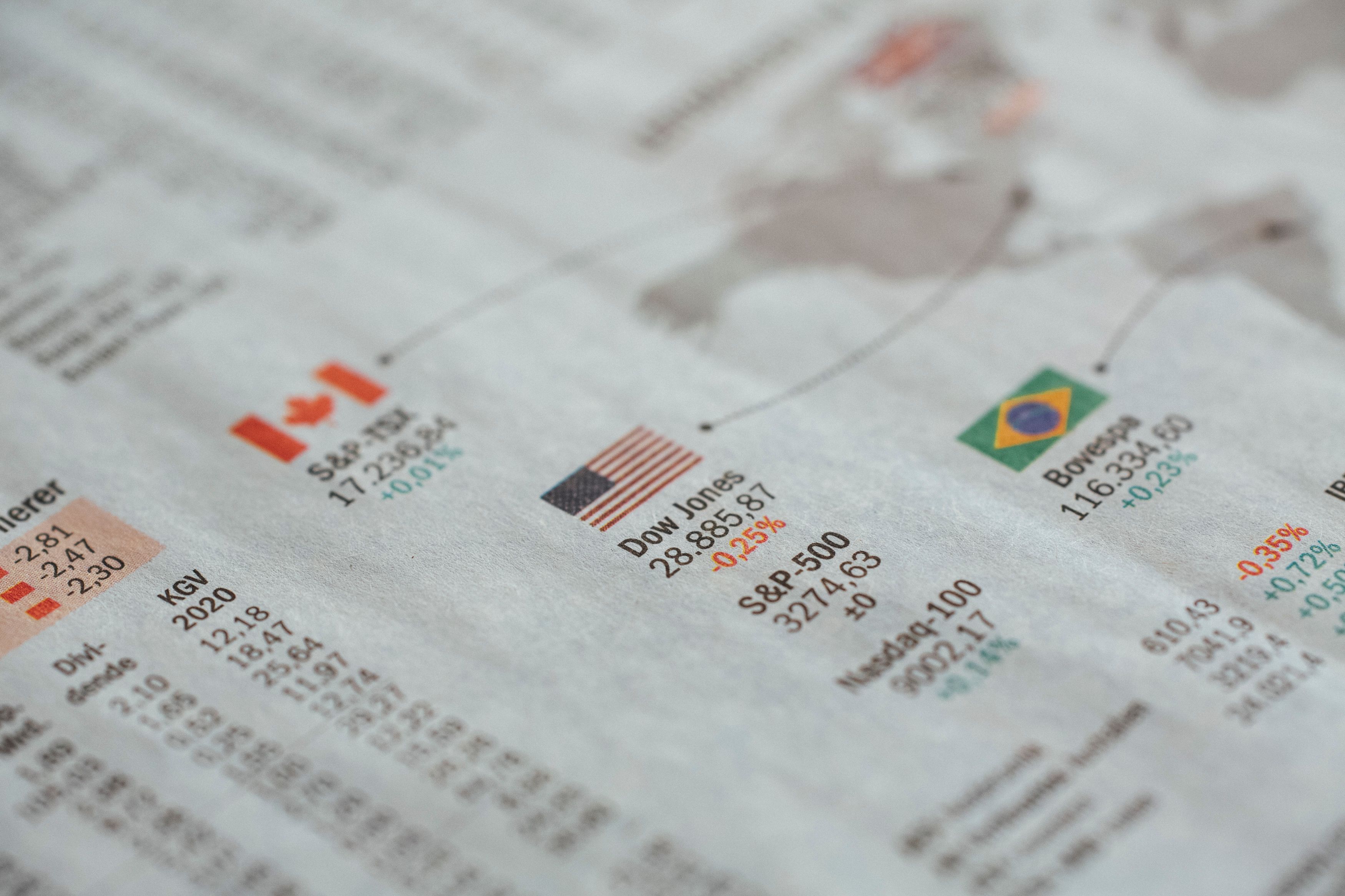 Newspaper displaying global financial market statistics and country flags