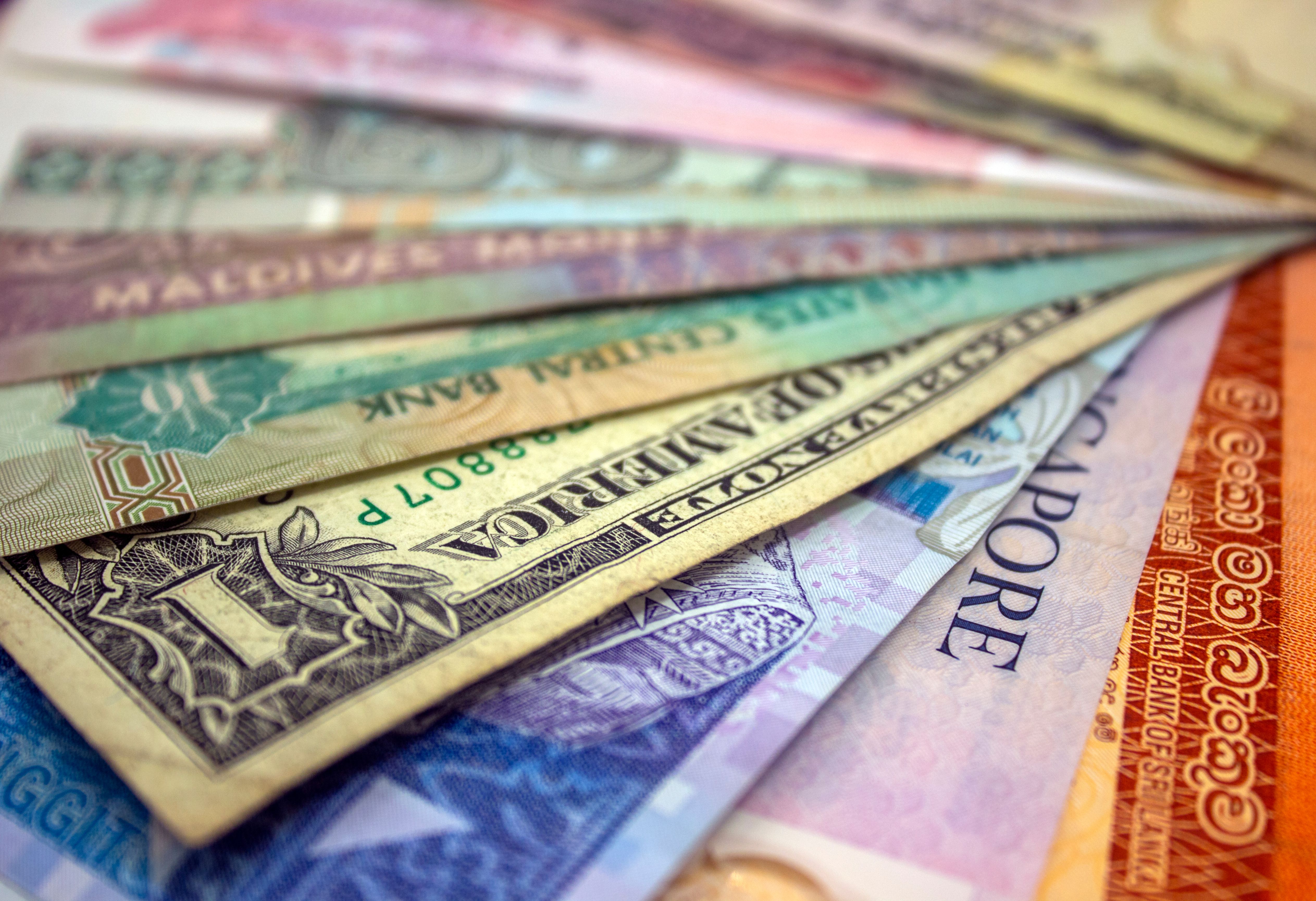 Close-up of various international banknotes showcasing diverse world currencies