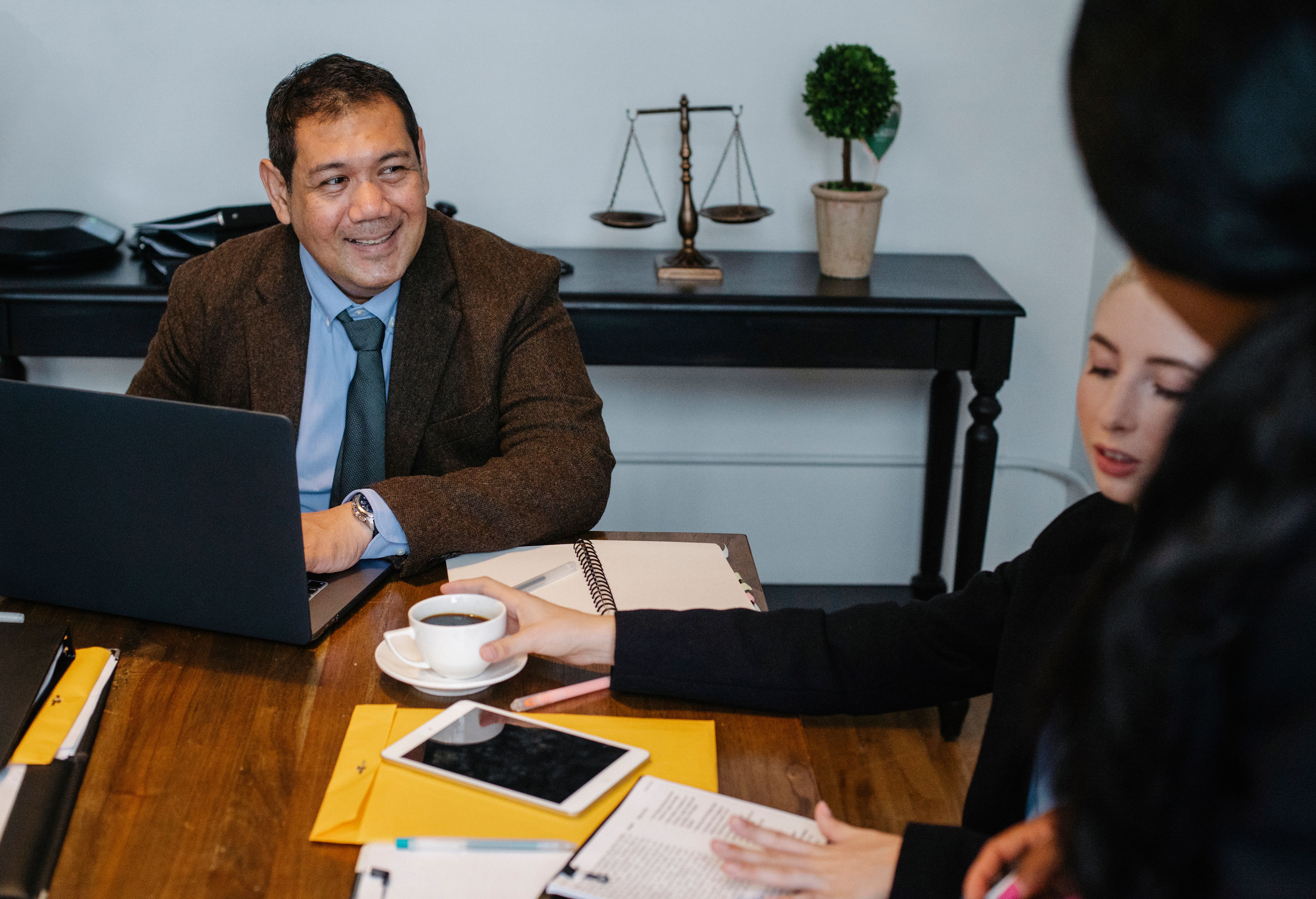 Law office team discussing business strategy around a conference table