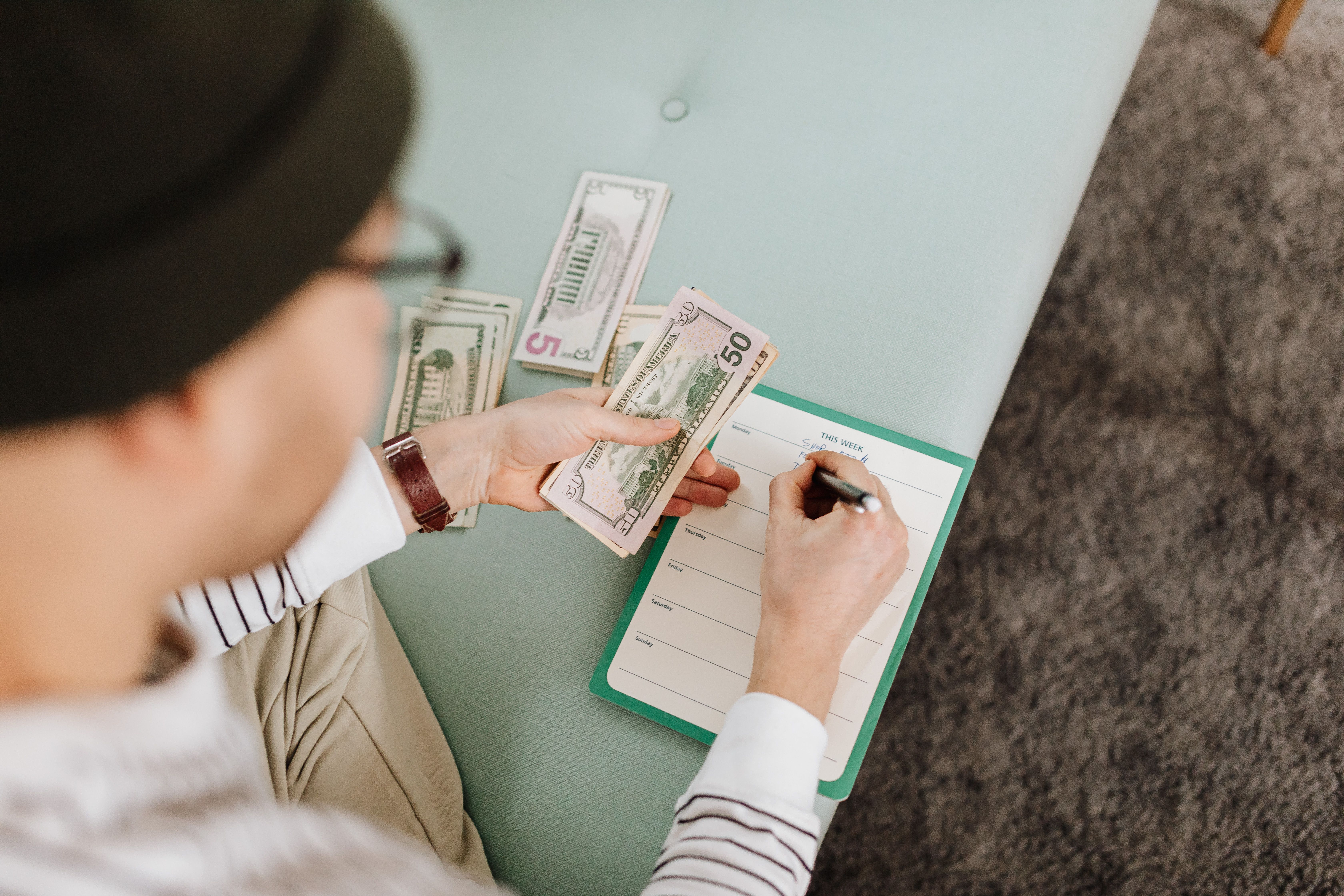 Budget planning with US dollars and a planner, representing smart home security spending.